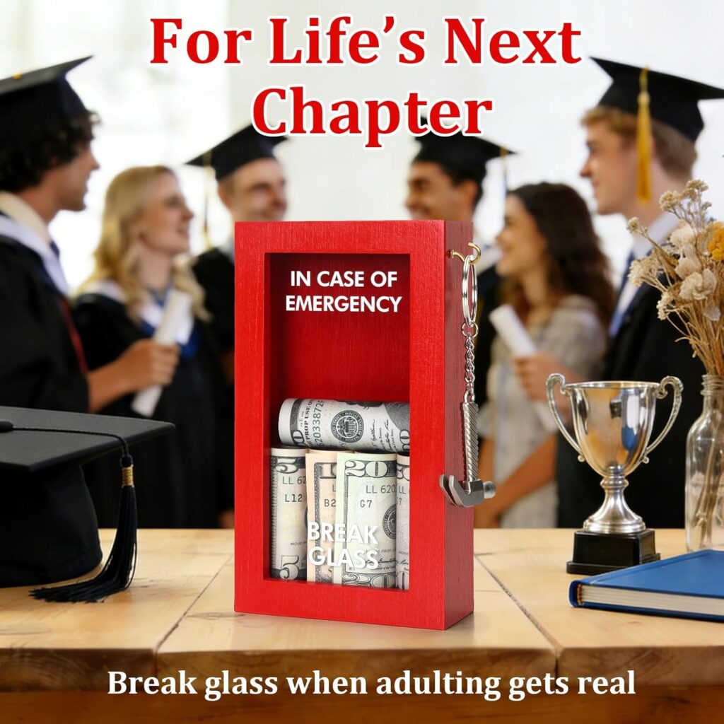 Emergency cash graduation gift box with money inside on a table surrounded by graduating high school seniors in caps and gowns